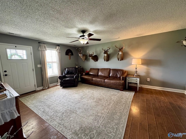 28035 Holland Gin Rd, Elkmont, AL 35620 - living area featuring a textured ceiling, ceiling fan, and dark wood finished floors