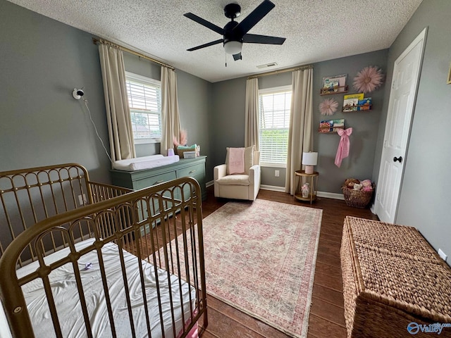28035 Holland Gin Rd, Elkmont, AL 35620 - bedroom with a textured ceiling, wood finished floors, and ceiling fan