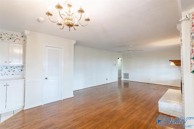 unfurnished living room with crown molding, dark hardwood / wood-style flooring, and ceiling fan with notable chandelier