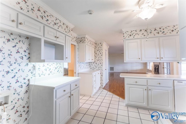 kitchen with white cabinetry, ceiling fan, crown molding, white dishwasher, and light tile patterned floors