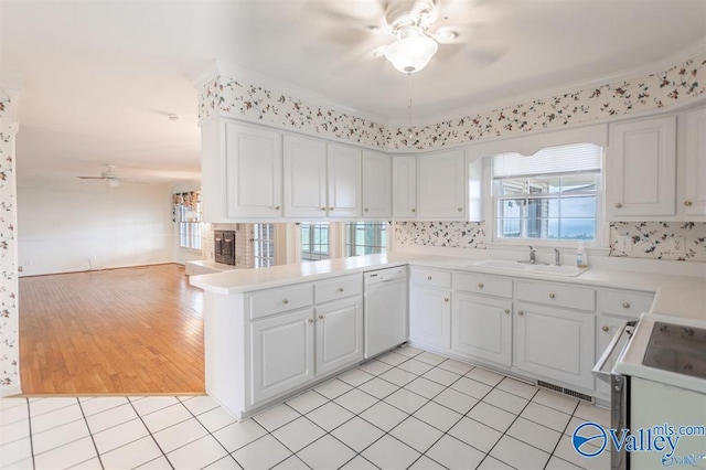 kitchen with white cabinetry, sink, kitchen peninsula, white appliances, and light tile patterned flooring