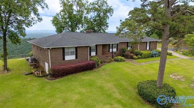 ranch-style house featuring central air condition unit and a front yard