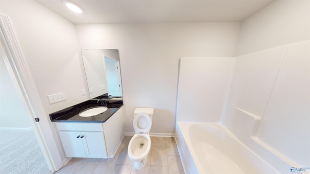 bathroom featuring vanity, a bath, and toilet