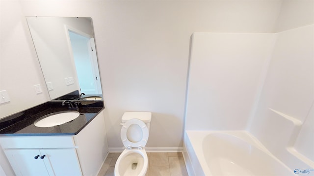 bathroom with vanity, a washtub, tile patterned floors, and toilet