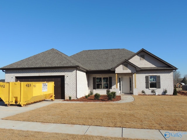 view of front of house with a garage and a front lawn