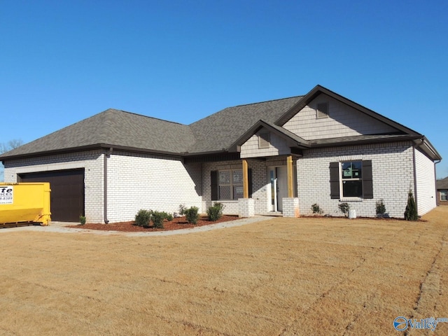 view of front of home with a garage and a front lawn