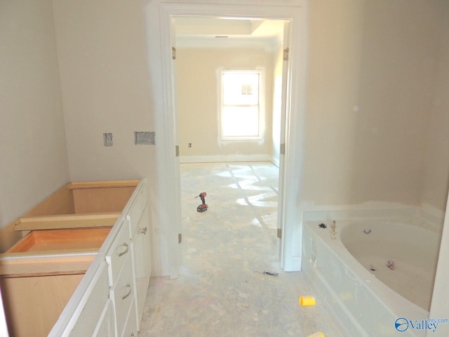 bathroom featuring vanity and a bath