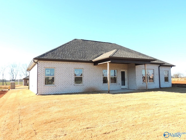 rear view of house featuring a yard