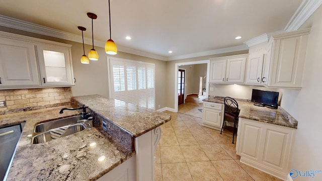 kitchen featuring pendant lighting, sink, stainless steel dishwasher, stone countertops, and white cabinetry