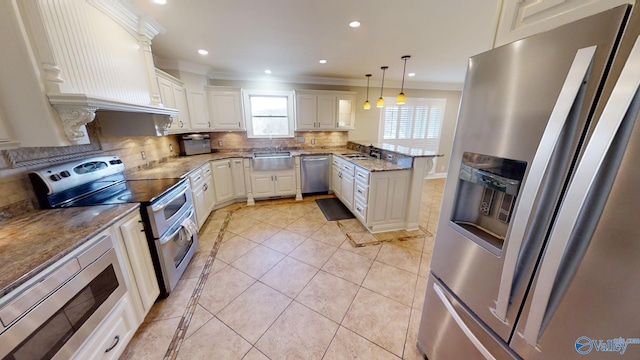 kitchen featuring backsplash, white cabinets, crown molding, hanging light fixtures, and stainless steel appliances