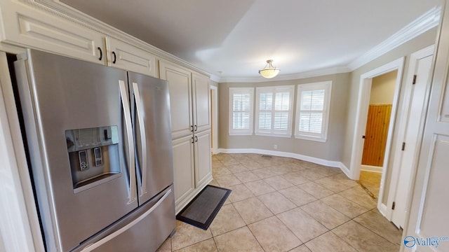 kitchen with stainless steel fridge, light tile patterned flooring, and ornamental molding