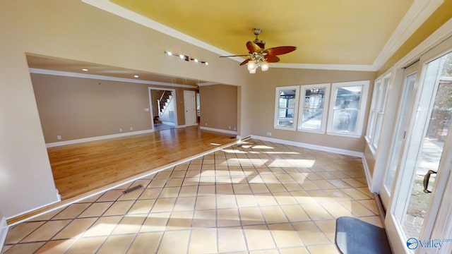 unfurnished room with lofted ceiling, light wood-type flooring, ceiling fan, and ornamental molding