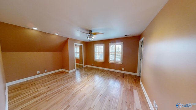 bonus room featuring ceiling fan, vaulted ceiling, and light wood-type flooring