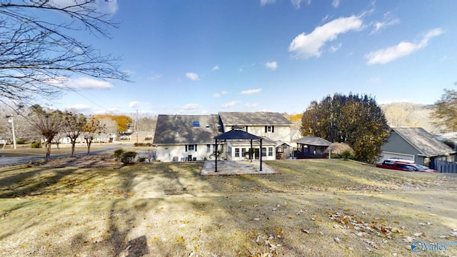 back of house with a gazebo, a yard, and a patio