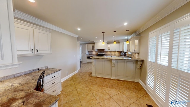 kitchen with backsplash, crown molding, light stone countertops, decorative light fixtures, and a breakfast bar area