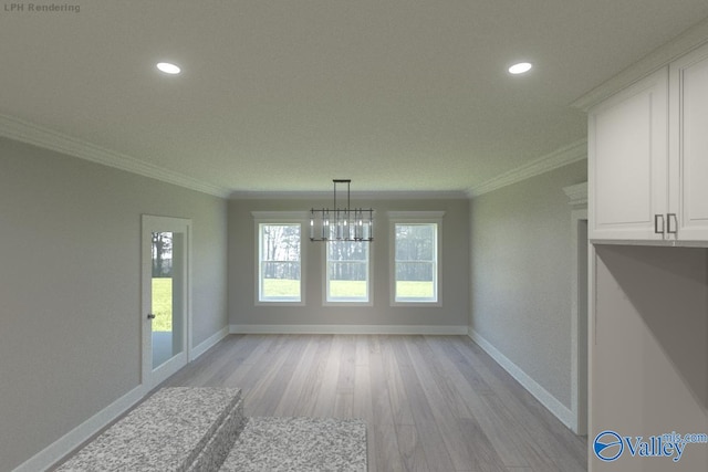 unfurnished dining area with crown molding, a notable chandelier, and light wood-type flooring