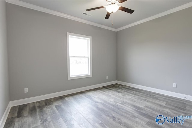 spare room with ceiling fan, wood-type flooring, and crown molding