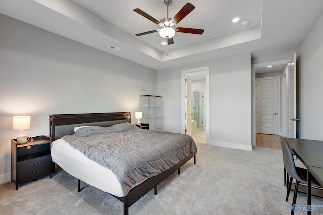 bedroom with light carpet, baseboards, visible vents, a tray ceiling, and recessed lighting