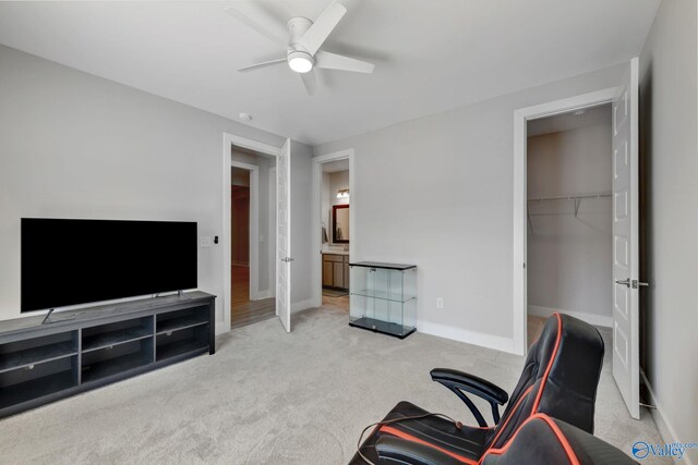 interior space featuring light carpet, ceiling fan, and baseboards