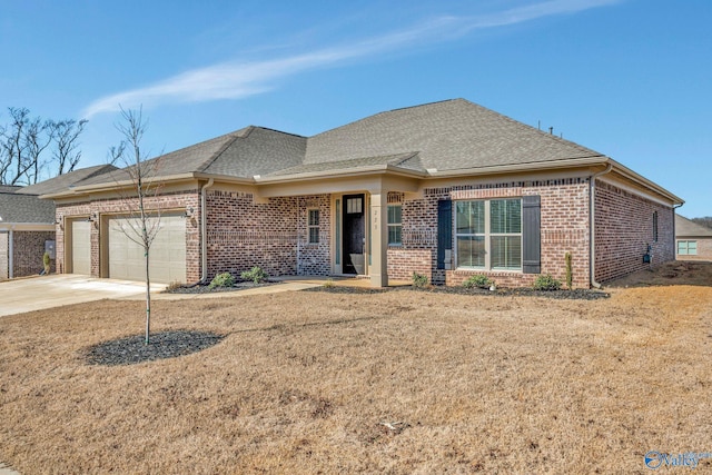 view of front of property with an attached garage, driveway, a shingled roof, and brick siding