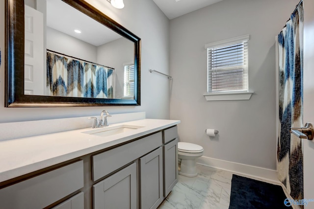 full bath featuring curtained shower, toilet, vanity, baseboards, and marble finish floor