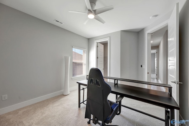 home office featuring light carpet, baseboards, visible vents, and a ceiling fan