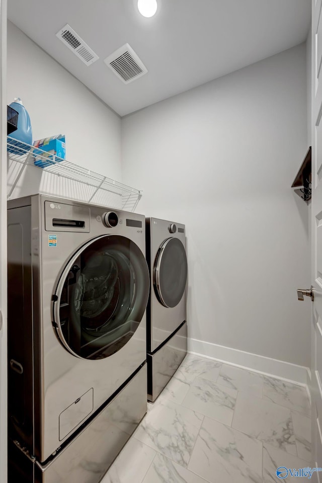 laundry area featuring marble finish floor, laundry area, and visible vents