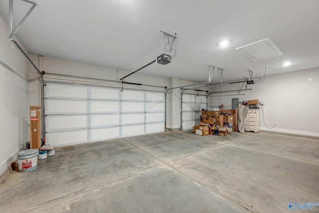 garage with baseboards and a garage door opener