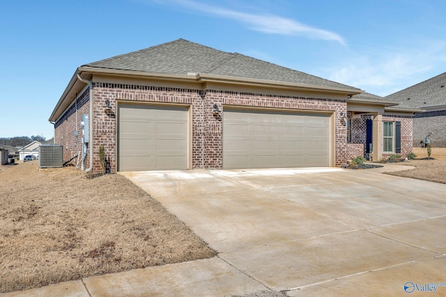 view of front of property featuring driveway, brick siding, and an attached garage