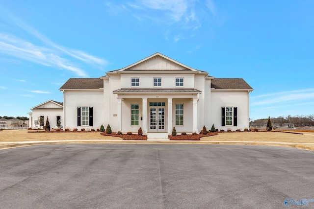 view of front of property featuring metal roof, french doors, and a standing seam roof