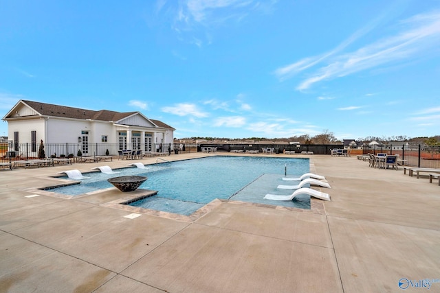 pool featuring a patio and fence