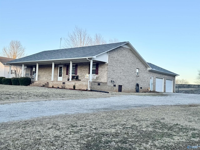 view of front of home with a porch and a garage