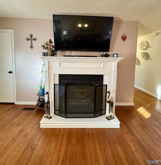 room details featuring hardwood / wood-style floors and a textured ceiling