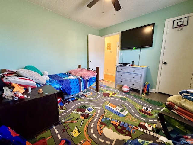 bedroom featuring wood-type flooring, a textured ceiling, and ceiling fan