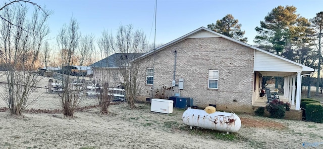 back of house featuring a porch and central AC unit