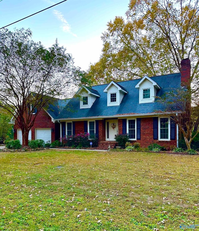 new england style home featuring a front yard and a garage