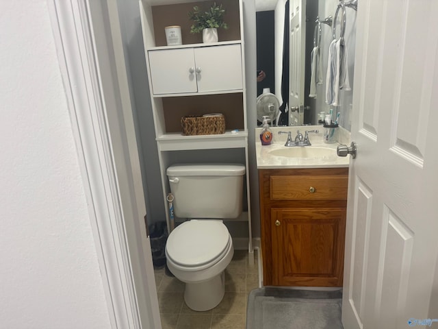 bathroom with vanity, toilet, and tile patterned floors