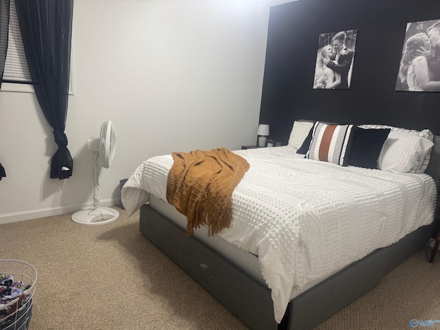 bedroom featuring carpet floors and baseboards