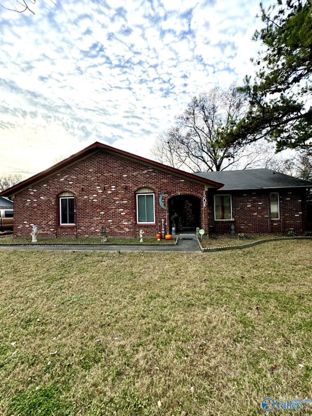 rear view of property with a lawn and a garage