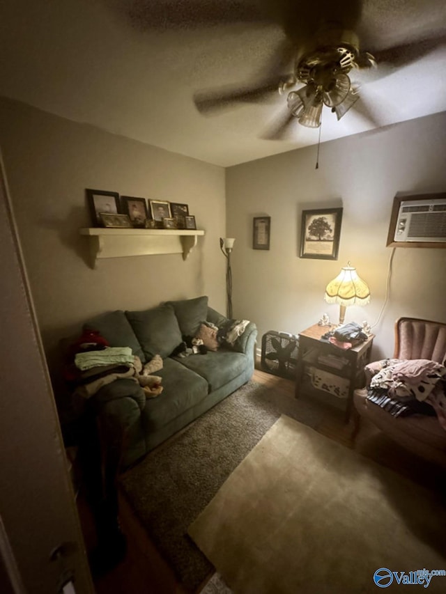 carpeted living room with ceiling fan and a wall mounted air conditioner