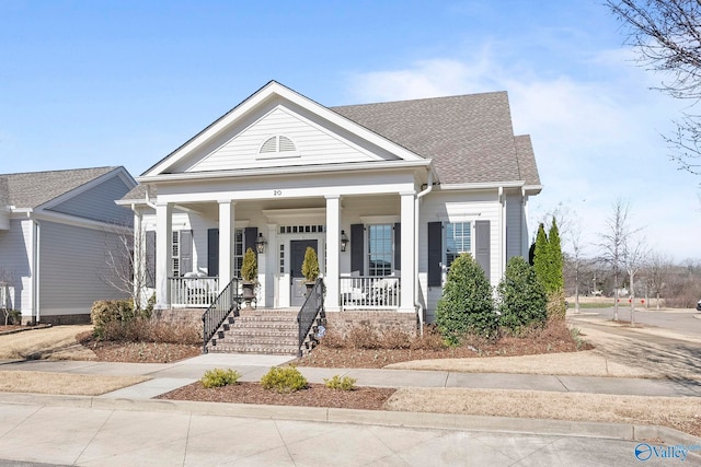 neoclassical home featuring a porch