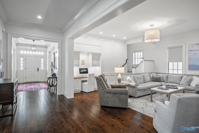 living room with dark wood finished floors, a decorative wall, recessed lighting, and crown molding