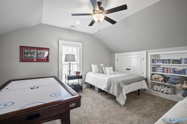 carpeted bedroom with visible vents, ceiling fan, and vaulted ceiling