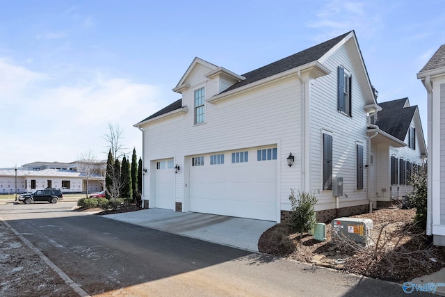 view of property exterior with driveway and a garage