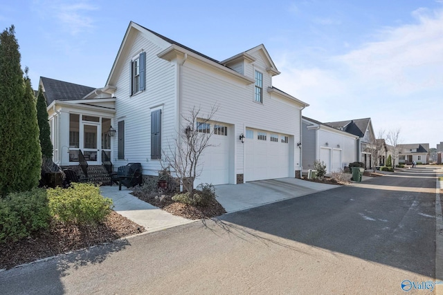 20 Lendon Main St SE, Huntsville, AL 35802 - view of home's exterior with concrete driveway, a garage, and a sunroom