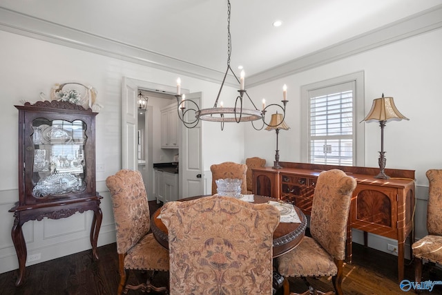 dining space with a chandelier, dark wood finished floors, and crown molding