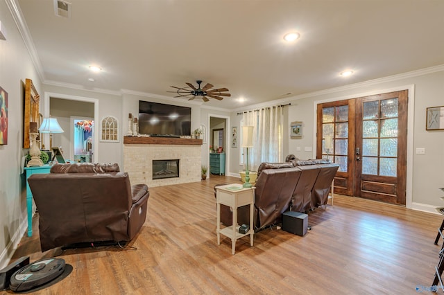 living room with french doors, ceiling fan, ornamental molding, and light hardwood / wood-style floors