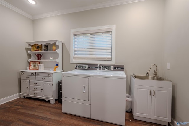 washroom with sink, washer and clothes dryer, dark hardwood / wood-style floors, cabinets, and ornamental molding