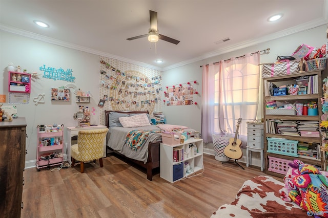 bedroom featuring ceiling fan, ornamental molding, and hardwood / wood-style floors