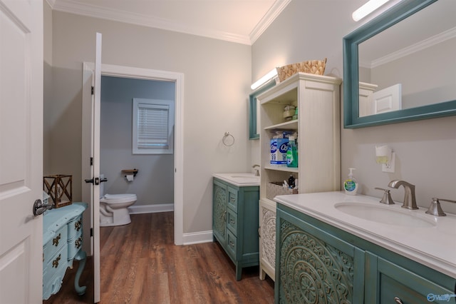 bathroom with vanity, crown molding, wood-type flooring, and toilet